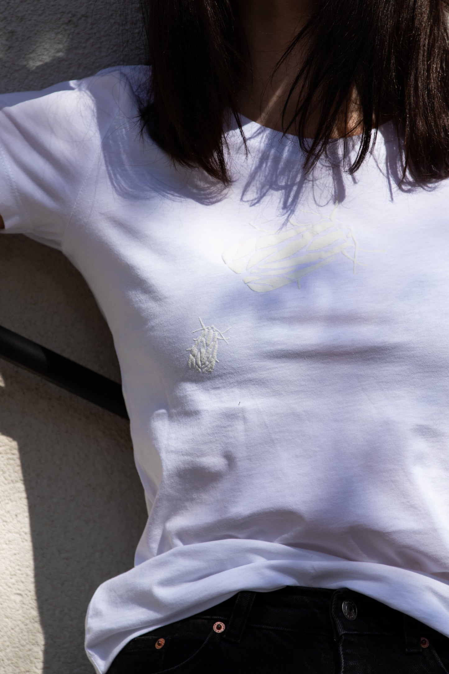 White T shirt and two small 3D bugs