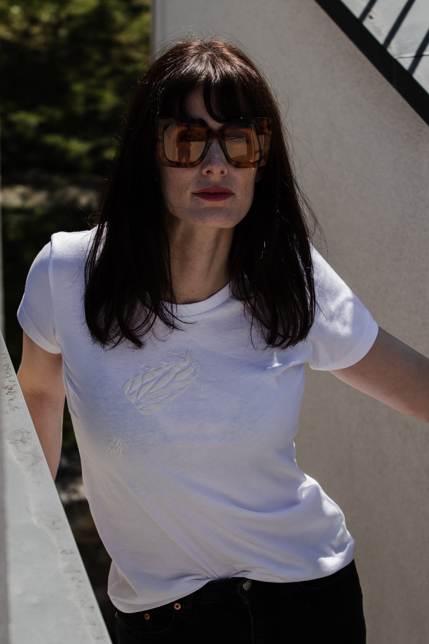 White T shirt and two small 3D bugs
