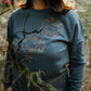 The iconic crew neck sweater with copper bubbles with a bug