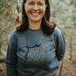 The iconic crew neck sweater with copper bubbles with a bug
