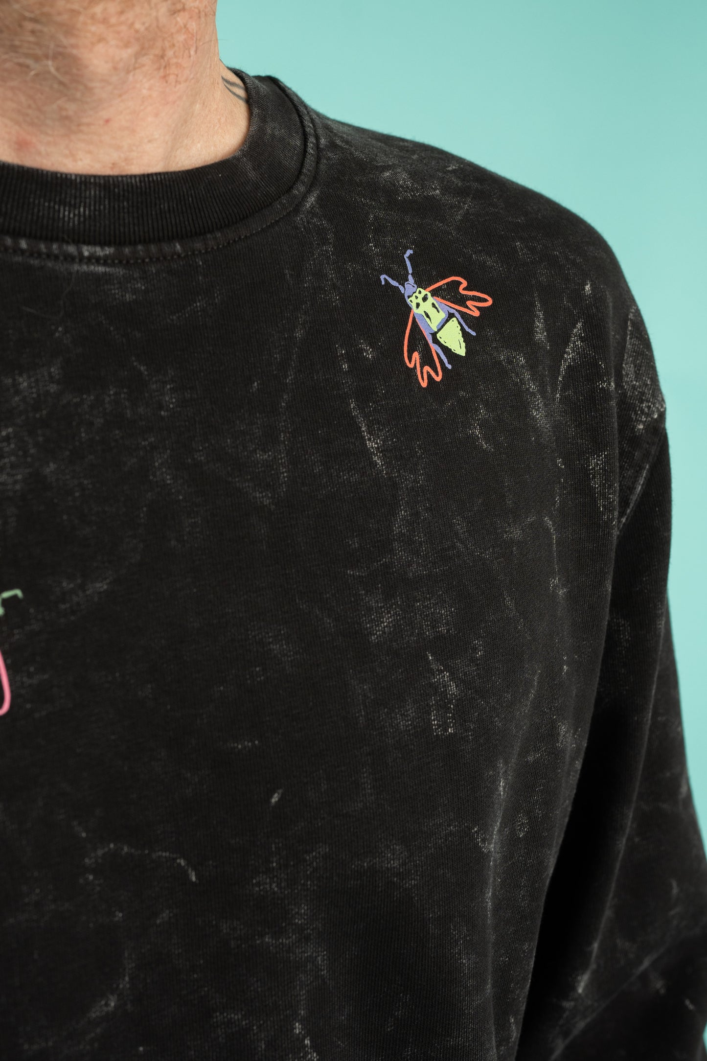 Black splatter sweater with a small bugs