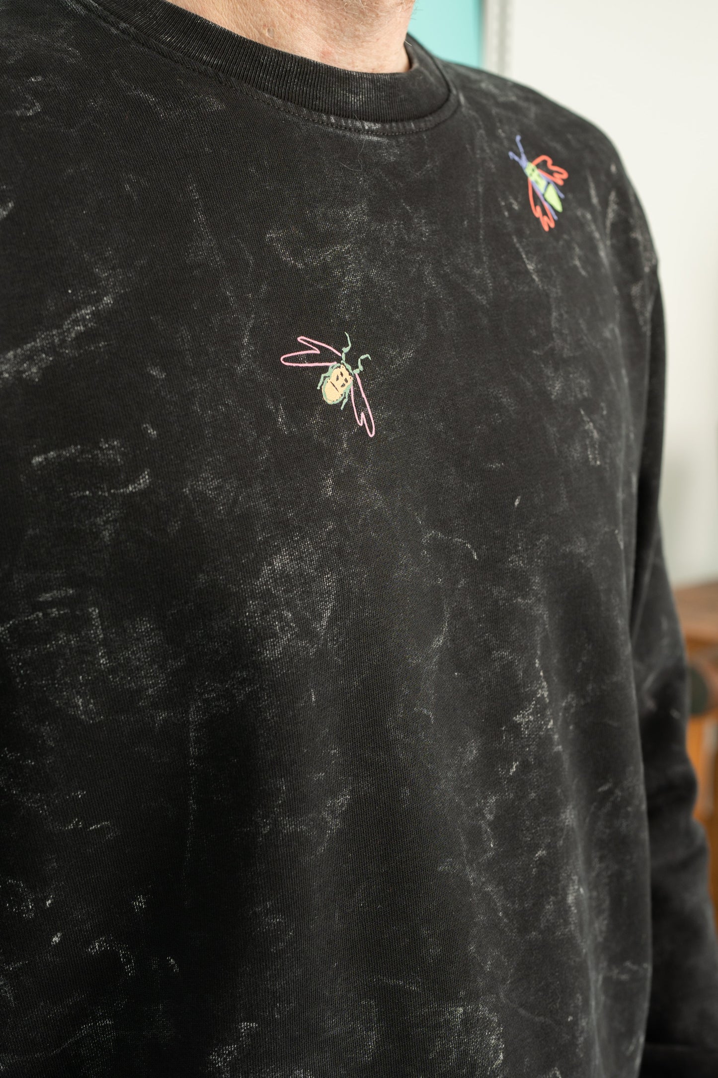 Black splatter sweater with a small bugs