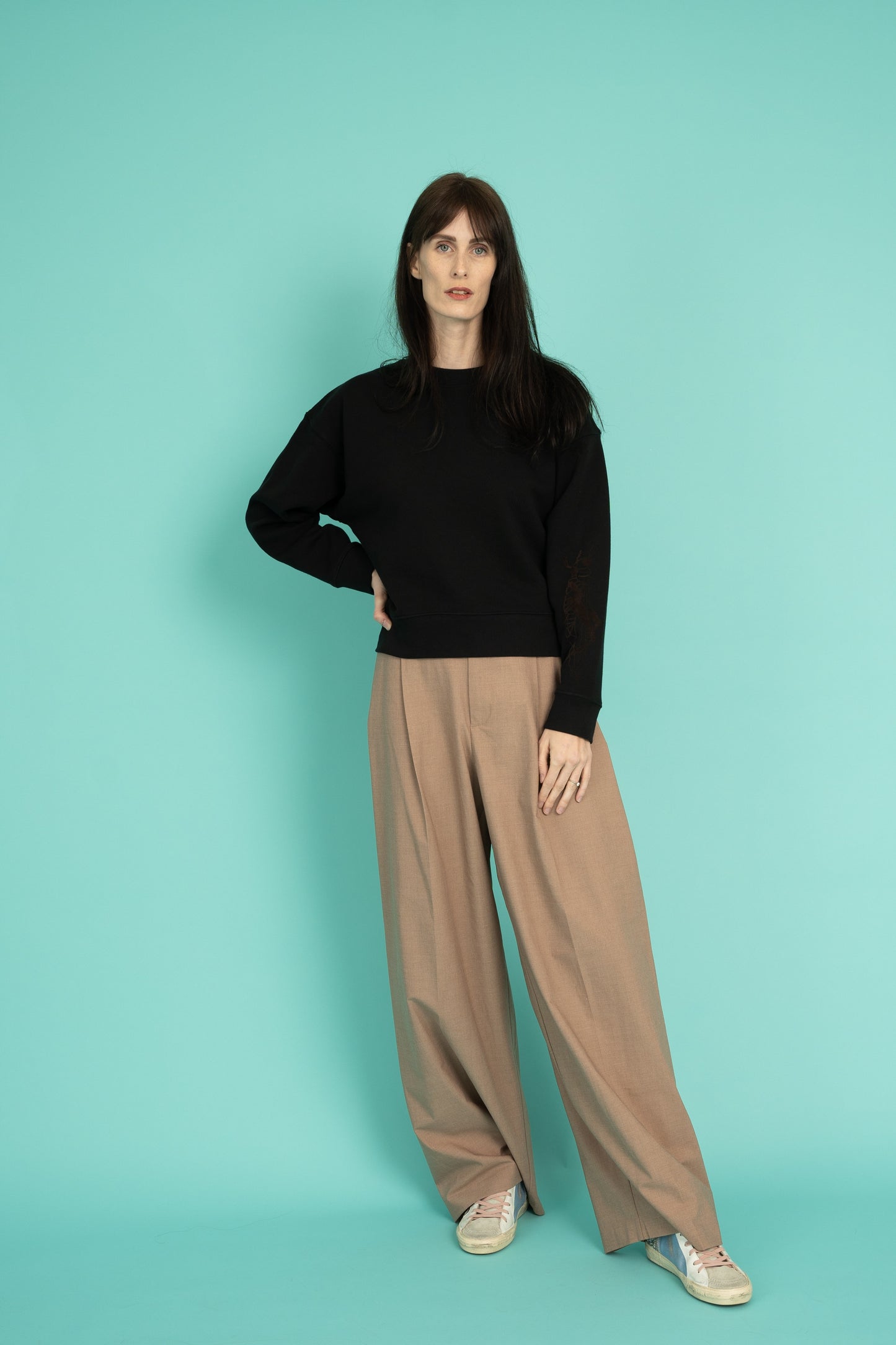 Black cropped crew neck sweatshirt with a grasshopper on the sleeve