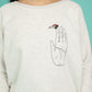 Light sweater in grey-white colour and ladybug bringing happiness