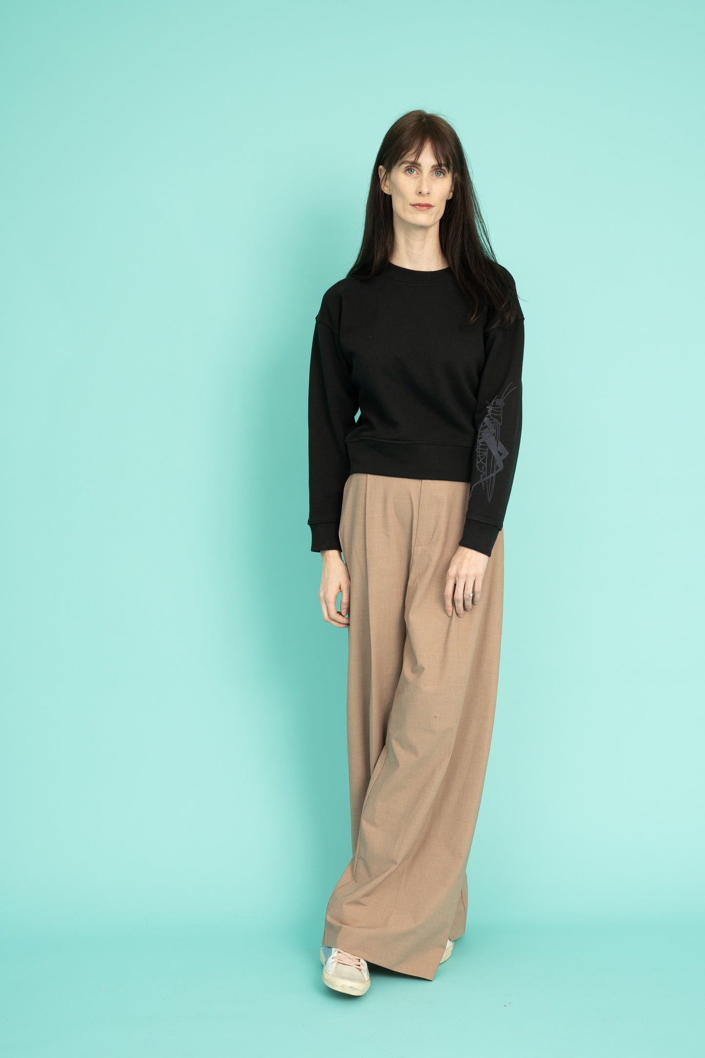 Black cropped crew neck sweatshirt with a grasshopper on the sleeve