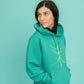 Turquoise hoodie and a walking stick in front