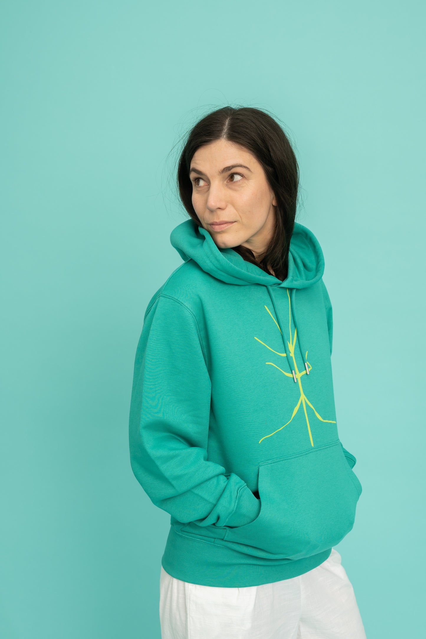 Turquoise hoodie and a walking stick in front