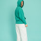Turquoise hoodie and a walking stick in front