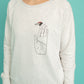 Light sweater in grey-white colour and ladybug bringing happiness