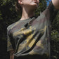 Golden scarab with black plush heart on a military pattern tee
