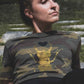 Golden scarab with black plush heart on a military pattern tee