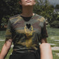 Golden scarab with black plush heart on a military pattern tee