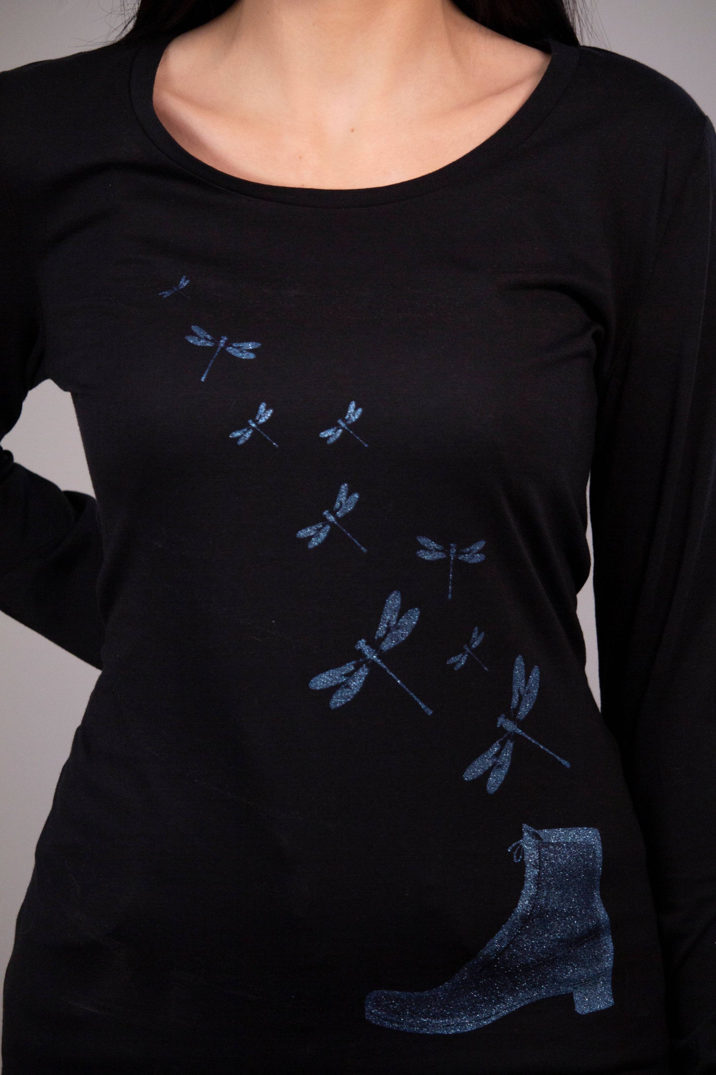 Shiny blue dragonflies fly out of boot women's tee